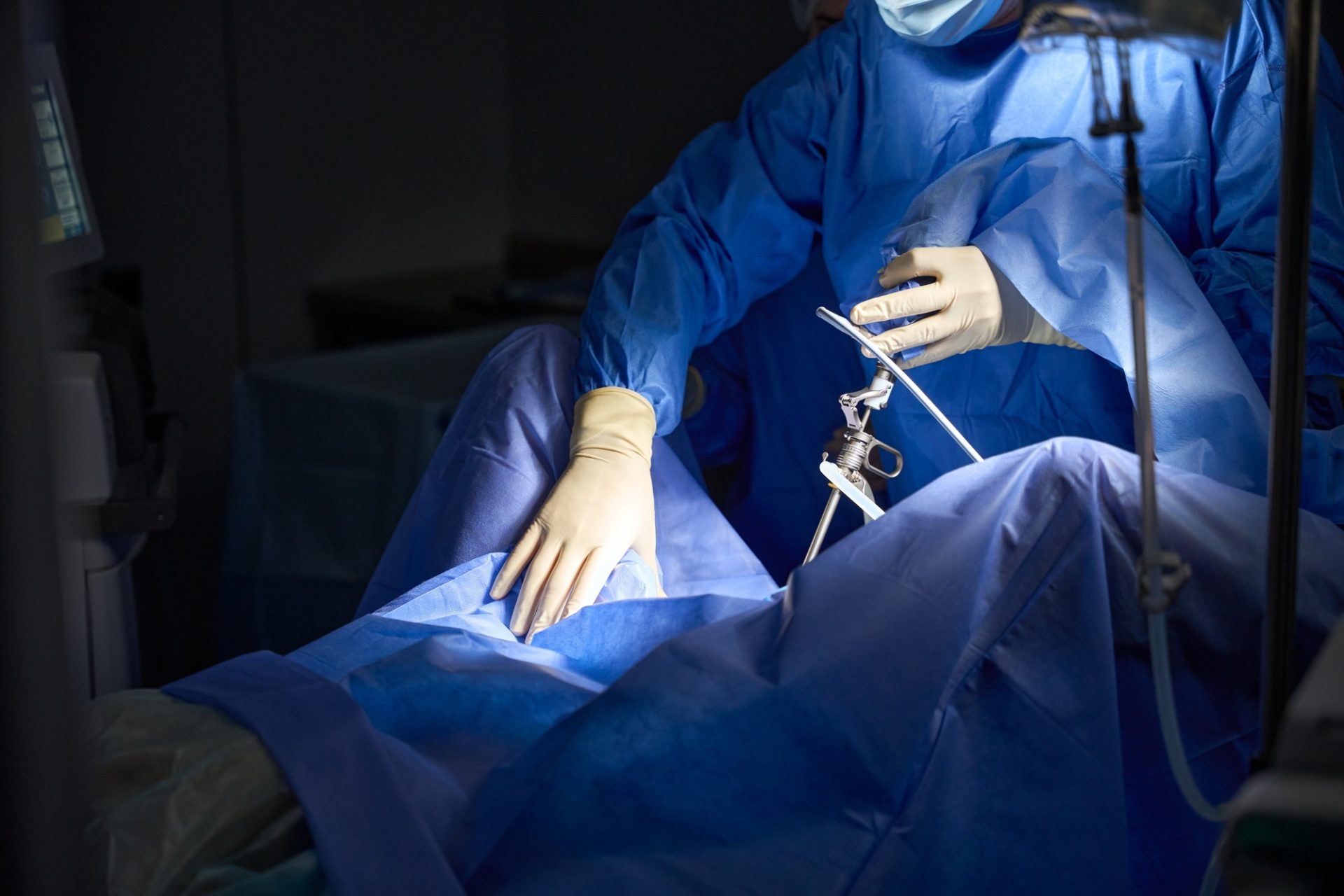 Male gynecologist preparing for endoscopy and laparoscopy in operation room