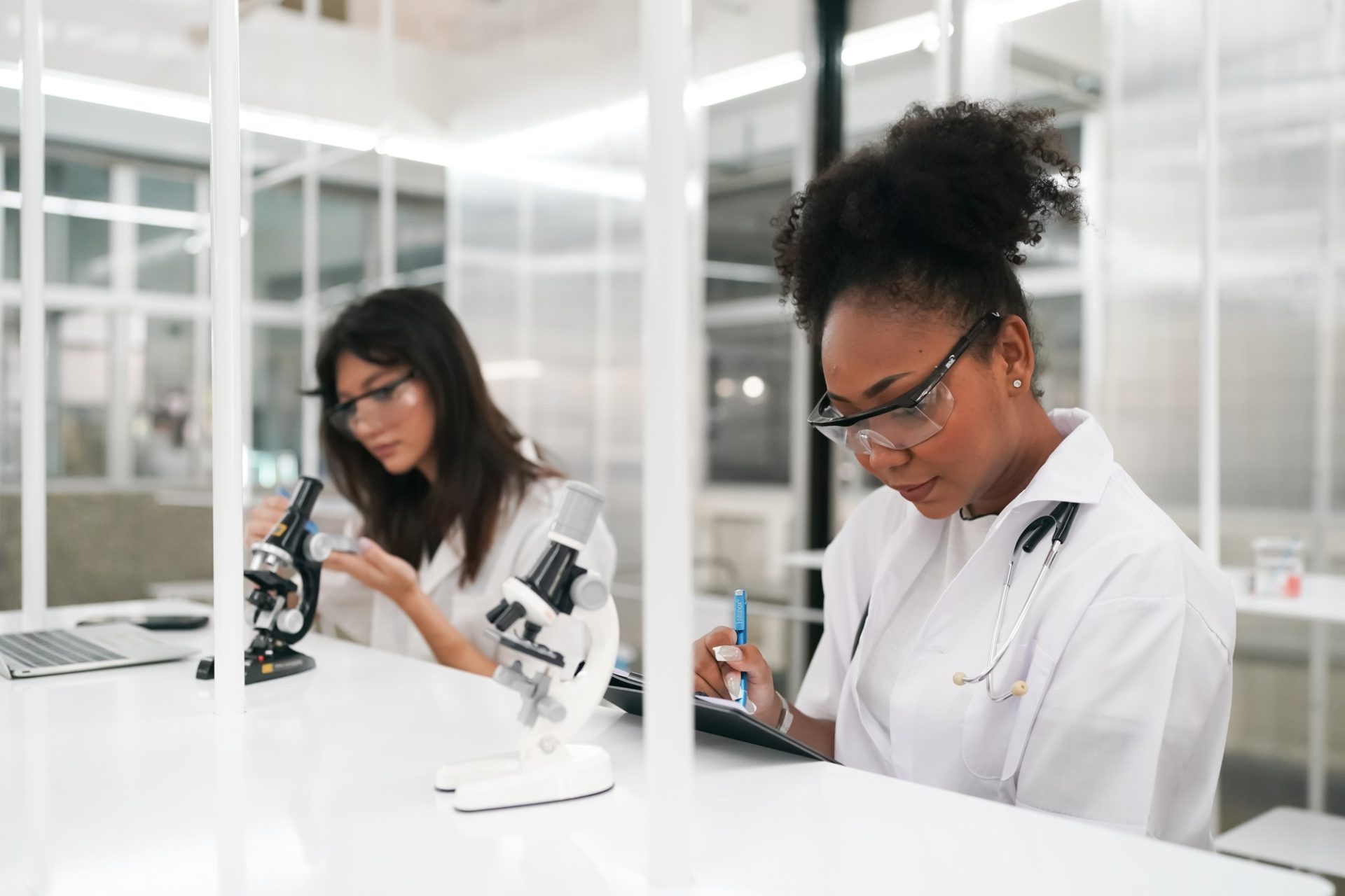 Medic working with microscope at the laboratory
